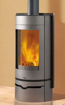 EDILKAMIN VOGUE  6 Kw. Plano fuego de fundición y fuego de refractario.Posibilidad salida humos superior / posterior.Troncos de leña de máximo 50 cm verticales.Salida humos Ø 15 cm.Con cajón para la leña.Revestimiento de acero bicolor: gris antracita y gr